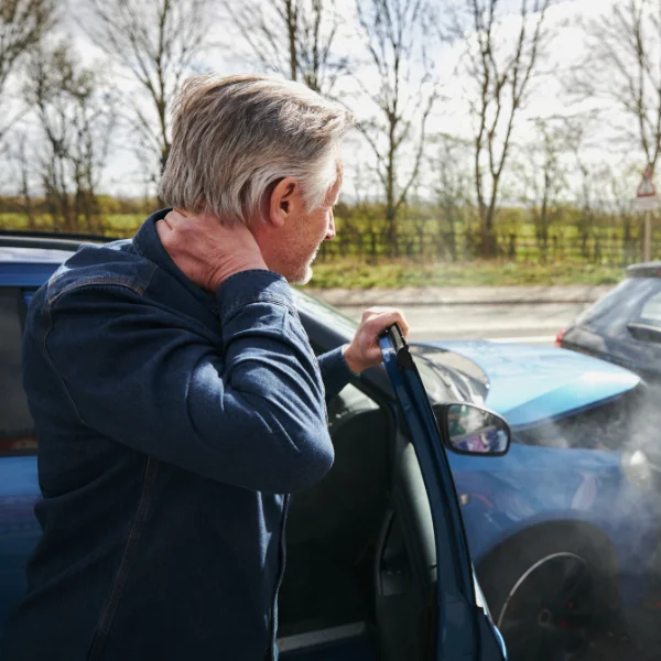 A driver experiencing whiplash after a motor vehicle accident in Alabama.
