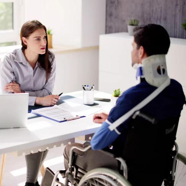 An image showing an attorney assisting an injured motorcyclist with auto accident claims.